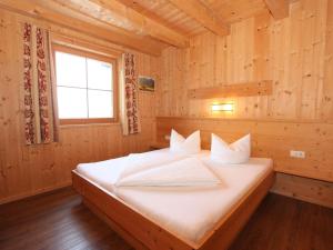 a bedroom with a bed in a wooden room at Chalet Chalet Elisabeth by Interhome in Juns