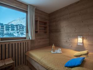 a bedroom with a bed and a large window at Apartment Les Genepis-5 by Interhome in Tignes