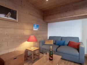 a living room with a couch and a table with a lamp at Apartment Les Genepis-5 by Interhome in Tignes