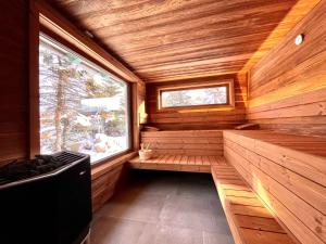 a sauna with a window in a wooden cabin at Holiday Home Katschberg 8 by Interhome in Rennweg