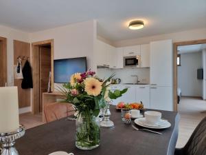 a vase of flowers on a table in a living room at Apartment Alpenschnucke Home by Interhome in See