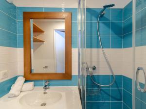 a bathroom with a sink and a shower with a mirror at Apartment Rond Point des Pistes - Val Claret-20 by Interhome in Tignes