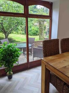 a dining room with a table and chairs and a patio at Seaside Cottage, 8min walk to beach. Dog friendly. in Norwich +28 photos