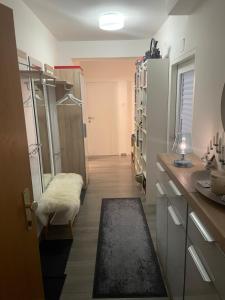 a room with a kitchen with a counter and a room with a refrigerator at Grenzberg Top 20 in Bad Gastein