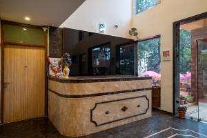 a bar in a house with a stone fireplace at Jivanta Mahabaleshwar in Mahabaleshwar +119 photos