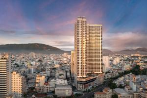 a city with a tall building in the foreground at Meliá Vinpearl Nha Trang Empire in Nha Trang