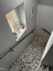 a staircase with a window and a tile floor at Garsonjera Zvezdara in Belgrade