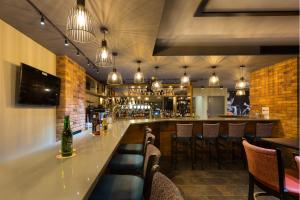 a bar in a restaurant with a counter and chairs at Castle Varagh Hotel & Bar in Westmeath