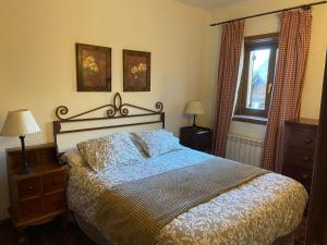 a bedroom with a large bed with blue and gold sheets at Baqueira Pleta de Neu in Naut Aran