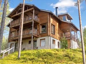 a large wooden house on a hill with trees at Holiday Home Nuovo casa a by Interhome in Sirkka