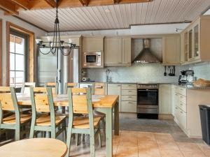 a kitchen with a wooden dining room table and chairs at Holiday Home Nuovo casa a by Interhome in Sirkka
