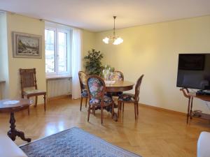 a dining room with a table and chairs and a television at Apartment Bieri-Haus by Interhome in Unterseen +21 photos