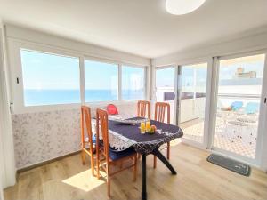 a dining room with a table and chairs and the ocean at Apartment Suecia by Interhome in Benidorm