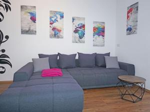a living room with a blue couch and a table at Apartment FeWo Anna by Interhome in Fliess