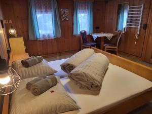 a room with three beds with pillows on them at Holiday Home Stark by Interhome in Kappl