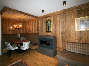 a living room with a fireplace and a table at Apartment Erzherzog's Apts-Zillertal Kaiser Lodge by Interhome in Uderns