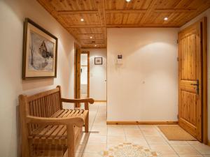 a hallway with a wooden bench and a door at Apartment Ambre 1 by Interhome in Villars-sur-Ollon