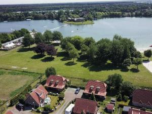 an aerial view of a house with a lake at Ferienwohnung Lüttje Huck - Seeblick 2 in Aurich
