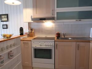 a kitchen with a white stove and a sink at Apartment Cyre by Interhome in Sainte-Croix