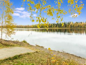 a view of a lake with trees in the background at Holiday Home Kojamopirtit by Interhome in Kolari