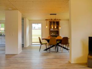 a dining room and kitchen with a table and chairs at Holiday Home Chalet Dori by Interhome in Interlaken