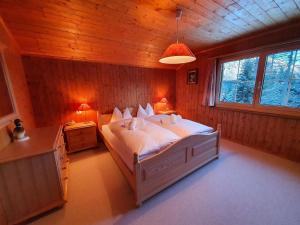 a bedroom with a large white bed in a room at Apartment Lieptgas by Interhome in Lenzerheide