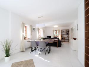 a kitchen and living room with a table and chairs at Holiday Home Posázaví by Interhome in Jílové u Prahy