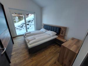 A bed or beds in a room at Chalet Diamondsky by Interhome