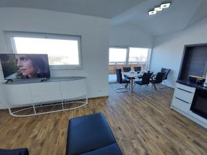 an office with a tv and a table and chairs at Chalet Diamondsky by Interhome in Klippitztorl