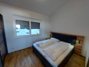 A bed or beds in a room at Chalet Diamondsky by Interhome