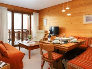 a living room with a table and a couch at Apartment Grand Hôtel B47 by Interhome in Villars-sur-Ollon