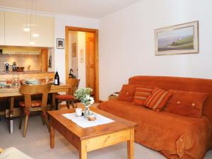 a living room with a couch and a table at Apartment Grand Hôtel B47 by Interhome in Villars-sur-Ollon