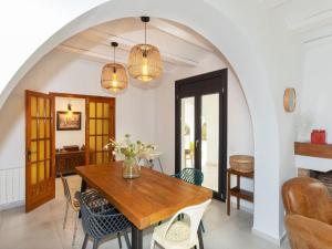 a dining room with a wooden table and chairs at Villa Gaia by Interhome in Miami Platja