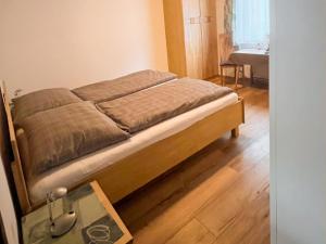 a bed sitting in a room with a table at Apartment Sonnenhang by Interhome 