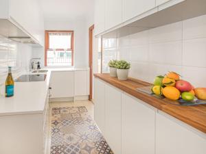 a kitchen with a plate of fruit on a counter at Apartment Nice 4 You by Interhome in Port d'Alcudia
