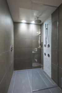 a bathroom with a shower stall and a toilet at Genting Hotel at Resorts World Birmingham in Bickenhill