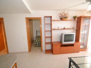 sala de estar con TV sobre una mesa de madera en Apartment Aguamarina-4 by Interhome en La Pineda