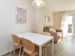 a living room with a white table and chairs at Apartment Apartamento los Pelicanos by Interhome in Miami Platja