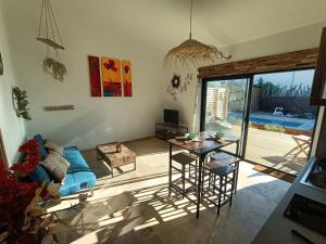 a living room with a table and a blue couch at Cocoon inn&Spa in Saint-Saturnin-les-Avignon