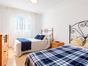 a bedroom with two beds with blue and white sheets at Apartment Jardimar by Interhome in Moncófar