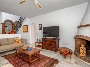 a living room with a tv and a fireplace at Villa Luna by Interhome in Sitio de Calahonda +24 photos