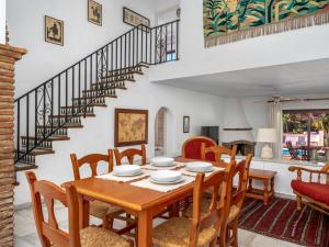 a dining room with a table and chairs and a staircase at Villa Luna by Interhome in Sitio de Calahonda