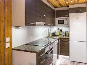 a kitchen with a sink and a refrigerator at Holiday Home Luppokero 3 by Interhome in Pyhätunturi