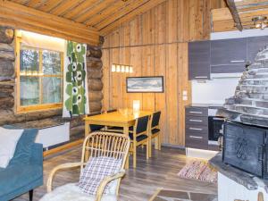 a kitchen and dining room with a table in a cabin at Holiday Home Luppokero 3 by Interhome in Pyhätunturi