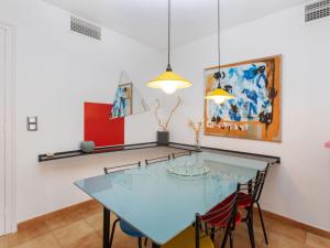een eetkamer met een blauwe tafel en stoelen bij Apartment Geminis by Interhome in Hospitalet de l'Infant
