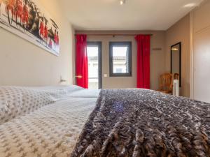 a bedroom with a large bed with red curtains at Holiday Home La Barca by Interhome in Cambrils