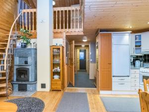 a kitchen with a fireplace and a staircase in a house at Holiday Home Antura b by Interhome in Pyhätunturi