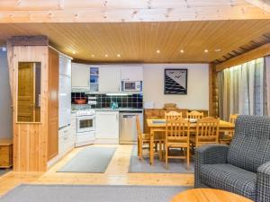 a kitchen and dining room with a table and chairs at Holiday Home Antura b by Interhome in Pyhätunturi