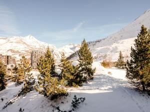 a group of trees in the snow in front of a mountain at Apartment Les Roches Rouges - Lavachet by Interhome in Tignes