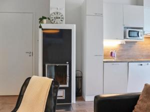 a living room with a clock on the wall at Holiday Home Skivillas 78 - 4 by Interhome in Hyrynsalmi +16 photos